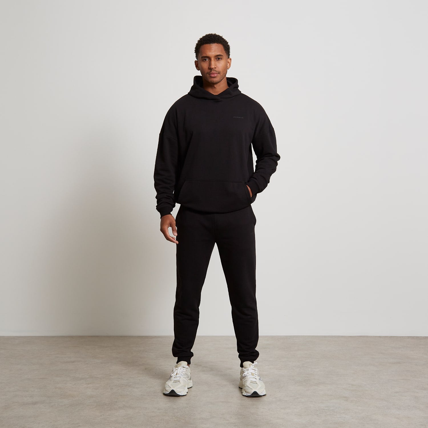 Mens matching black jogger and hoody set on a male model