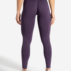 Purple leggings worn by a person on a white background