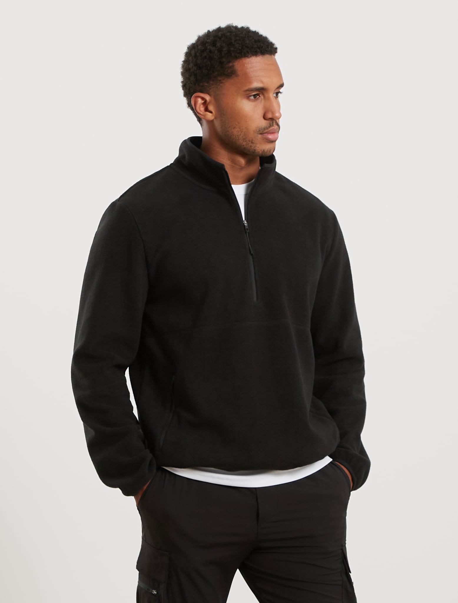 Man wearing a black fleece pullover on a white background