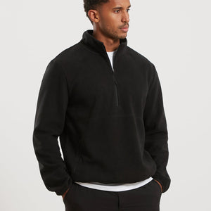 Man wearing a black fleece pullover on a white background