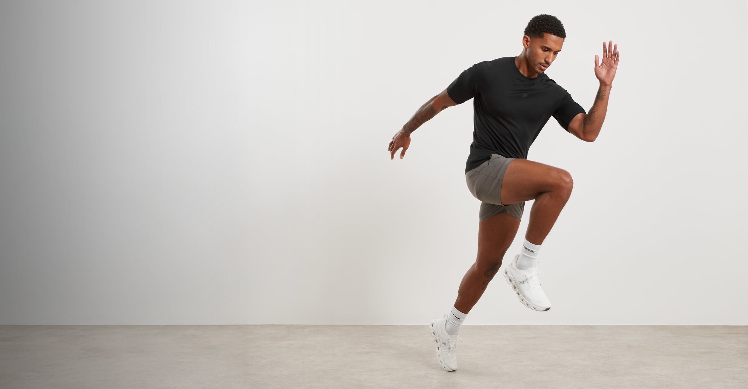 Person in athletic wear posing against a plain background