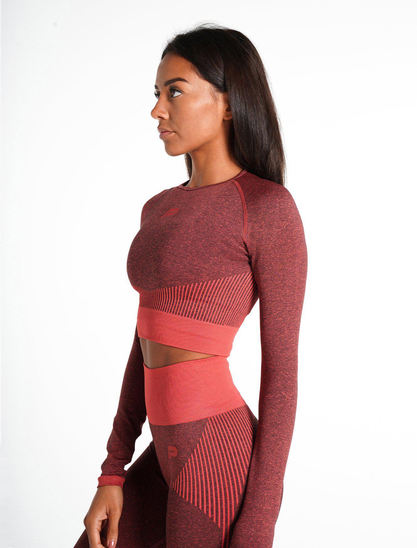 https://www.pursuefitness.com/cdn/shop/files/adapt-seamless-long-sleeve-crop-top-coral-quartz-womens.jpg?v=1691674845